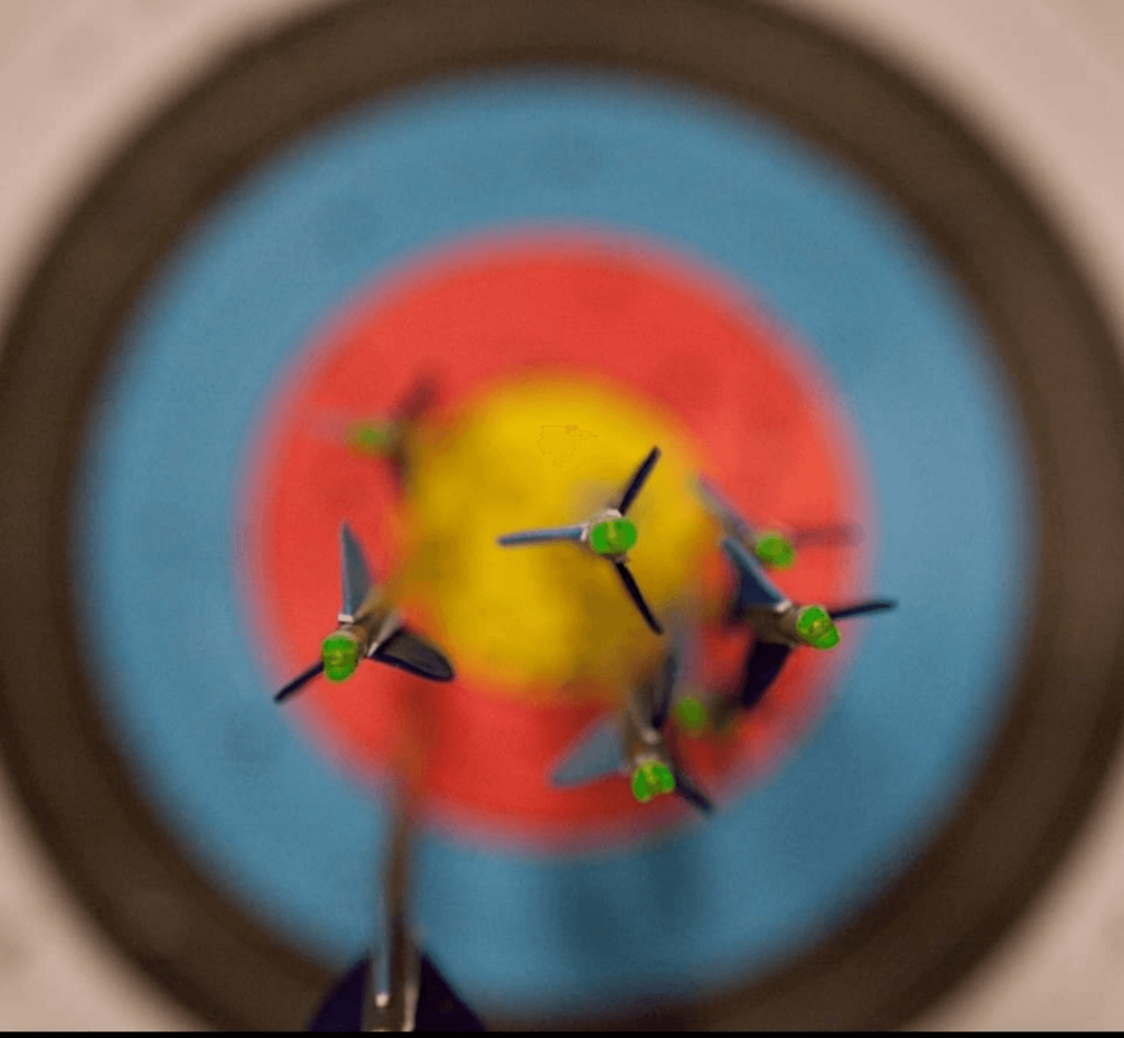 Arrows stuck in a target, most of them hitting the bullseye